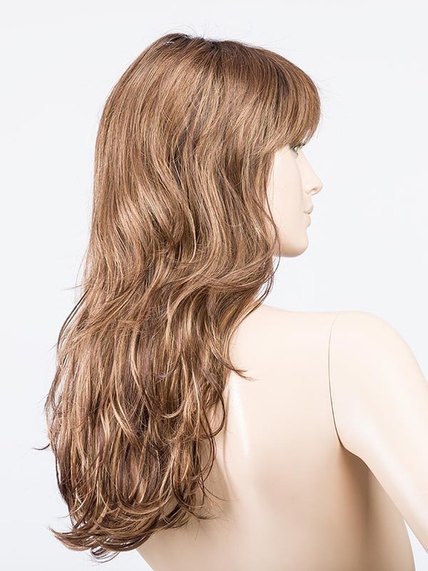 Perruque Pretty Hair Power : boucles Hollywood et frange épaisse, volume chic avec effet racines foncées ou balayage mix.