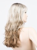 Perruque Pretty Hair Power : boucles Hollywood et frange épaisse, volume chic avec effet racines foncées ou balayage mix.